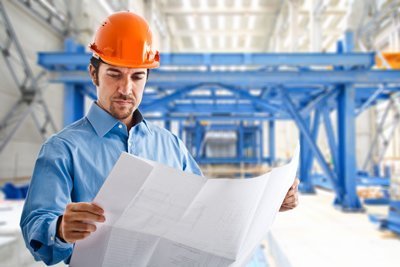 man looking at blueprints in a hard hat